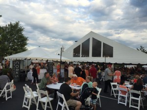 A view of the crowd and the tent for seating and the silent auction items 