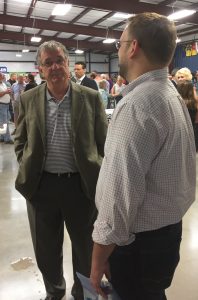 Knox County Commission candidate Justin Biggs on the right talking with Knoxville Businessman Bill Wyrick. Biggs handed out can koozies for the cold soft drink cans. They were put to great use.